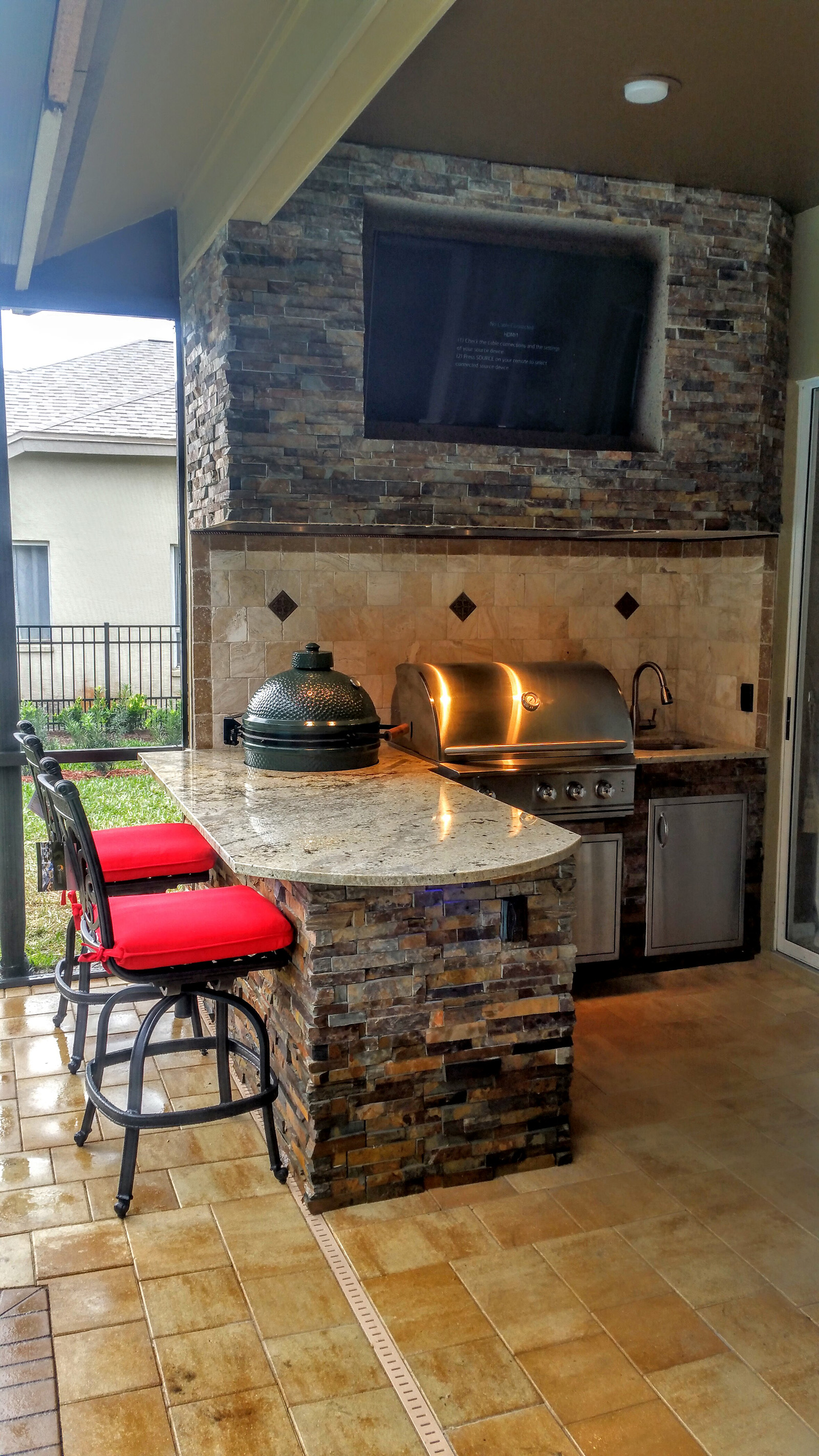 Granite and stonework Outdoor Kitchen with Entertainment - Creative