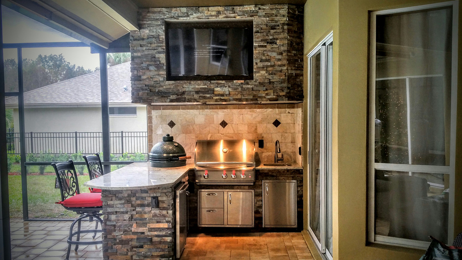 Granite and stonework Outdoor Kitchen with Entertainment - Creative